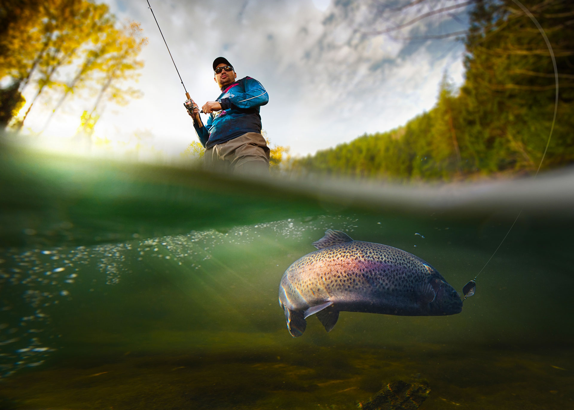 fly fisherman catching a trout on san juan river colorado